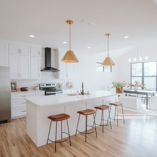 a kitchen with a center island with stools